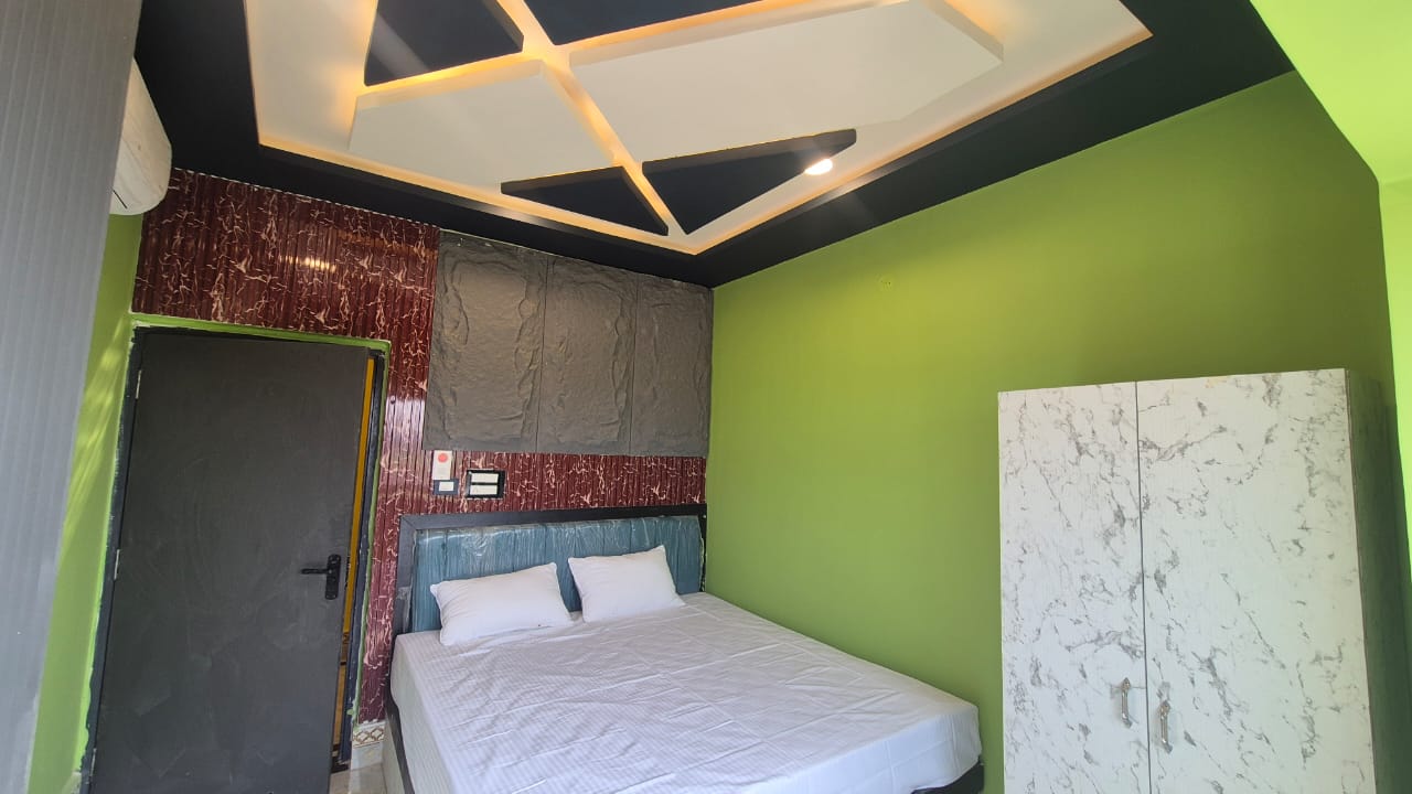 Standard Room with green accent wall, wardrobe and air conditioning