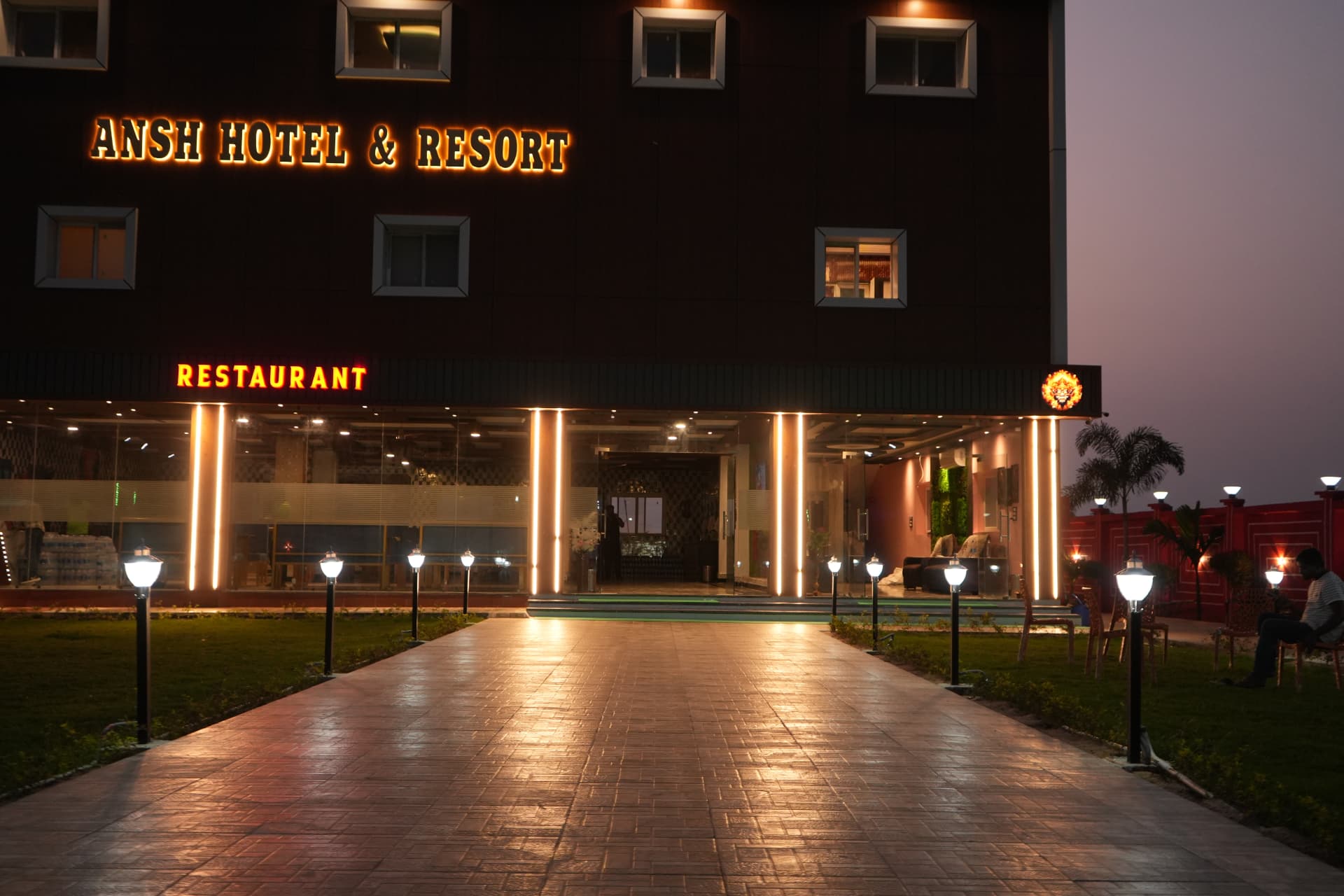 Hotel entrance walkway and restaurant at night