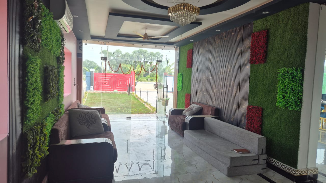 Lobby lounge with sofas and green feature walls at Ansh Hotel & Resort
