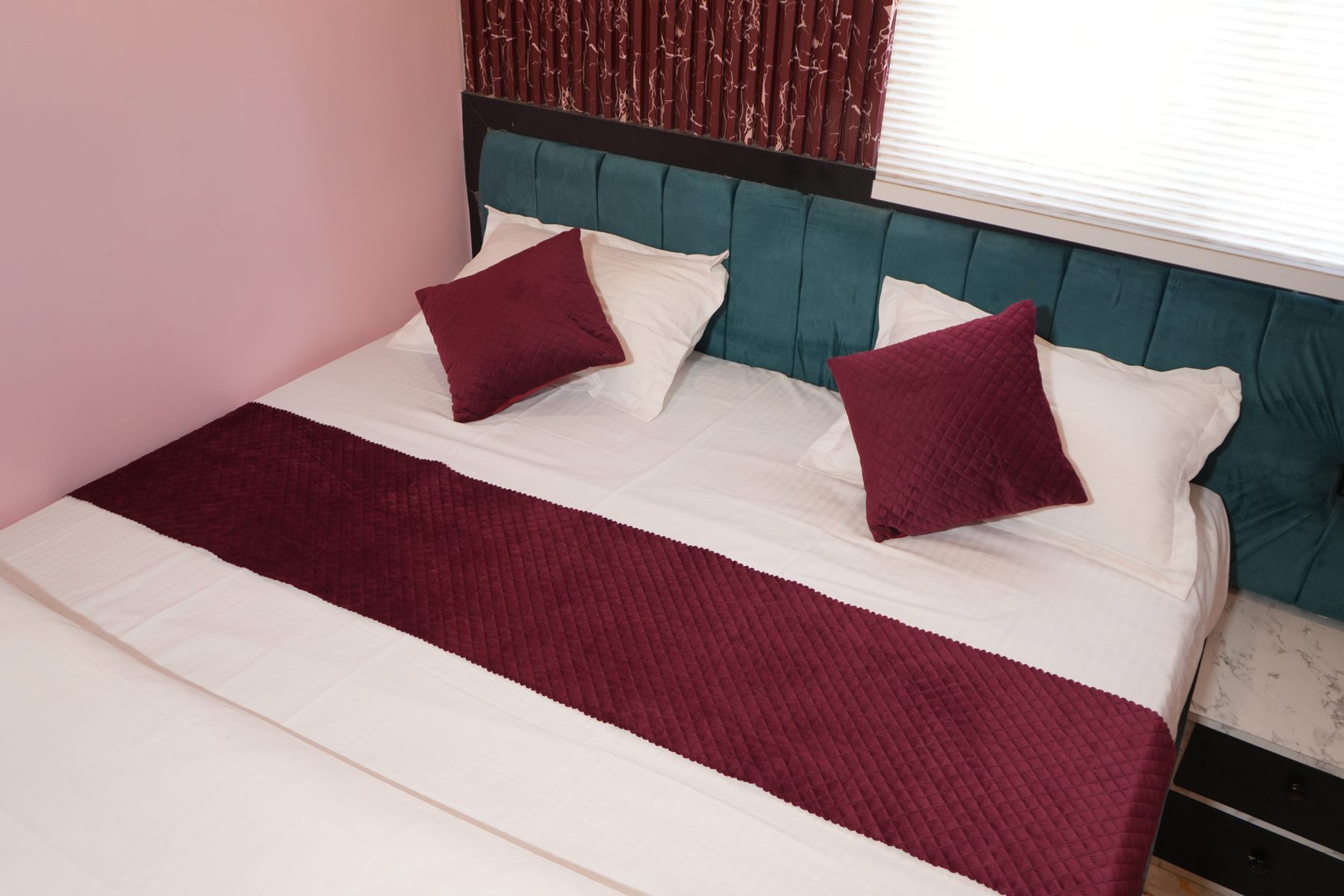Standard Room bed with headboard and cushions