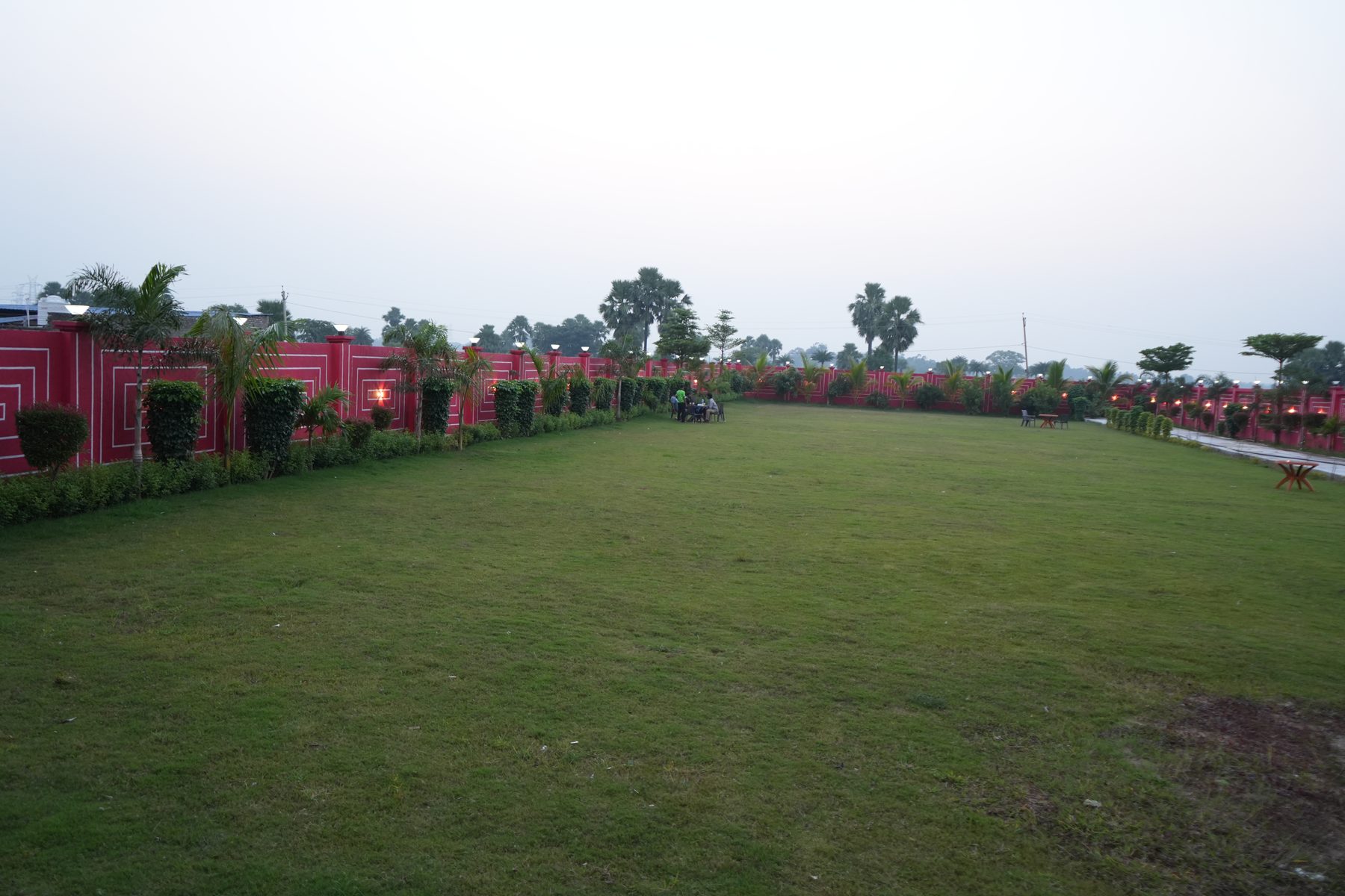 Open event lawn bordered by the perimeter wall