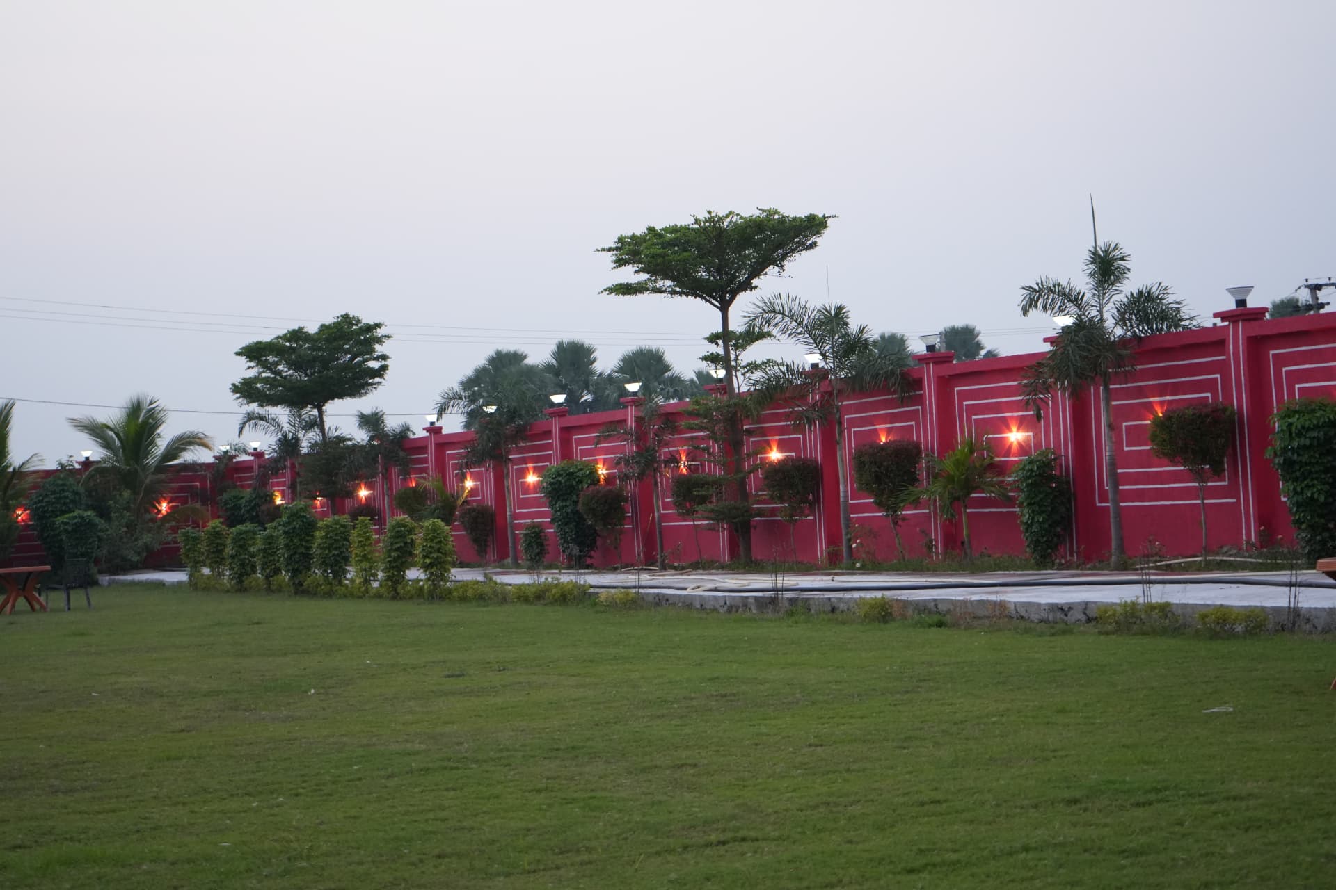 Wedding lawn and boundary wall lit up in the evening